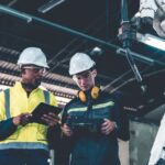 Industriarbetare intill robot